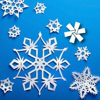 white paper snowflakes on a blue background
