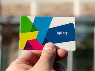 Person holding a library card