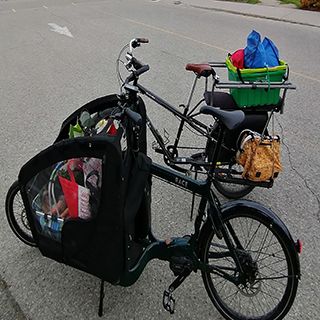 Two cargo bikes filled with groceries