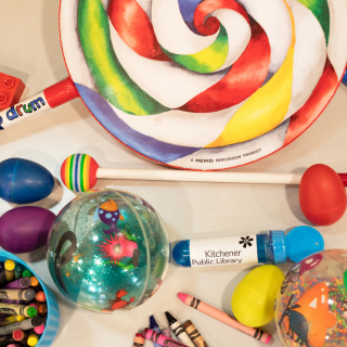 a colourful assortment of shakers, balls, crayons and other toys for toddlers to play with