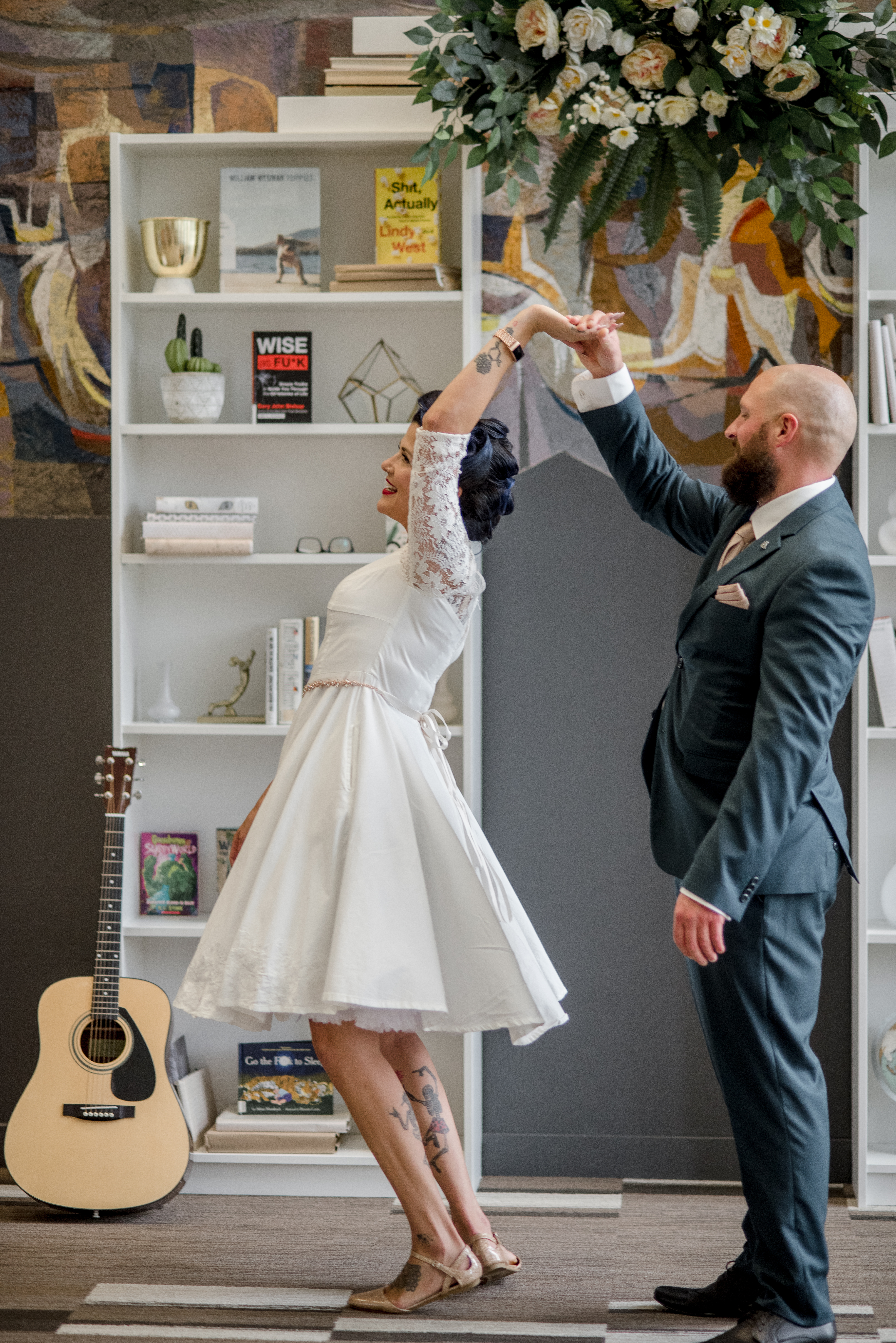 Twirling couple on their wedding day at Central Library