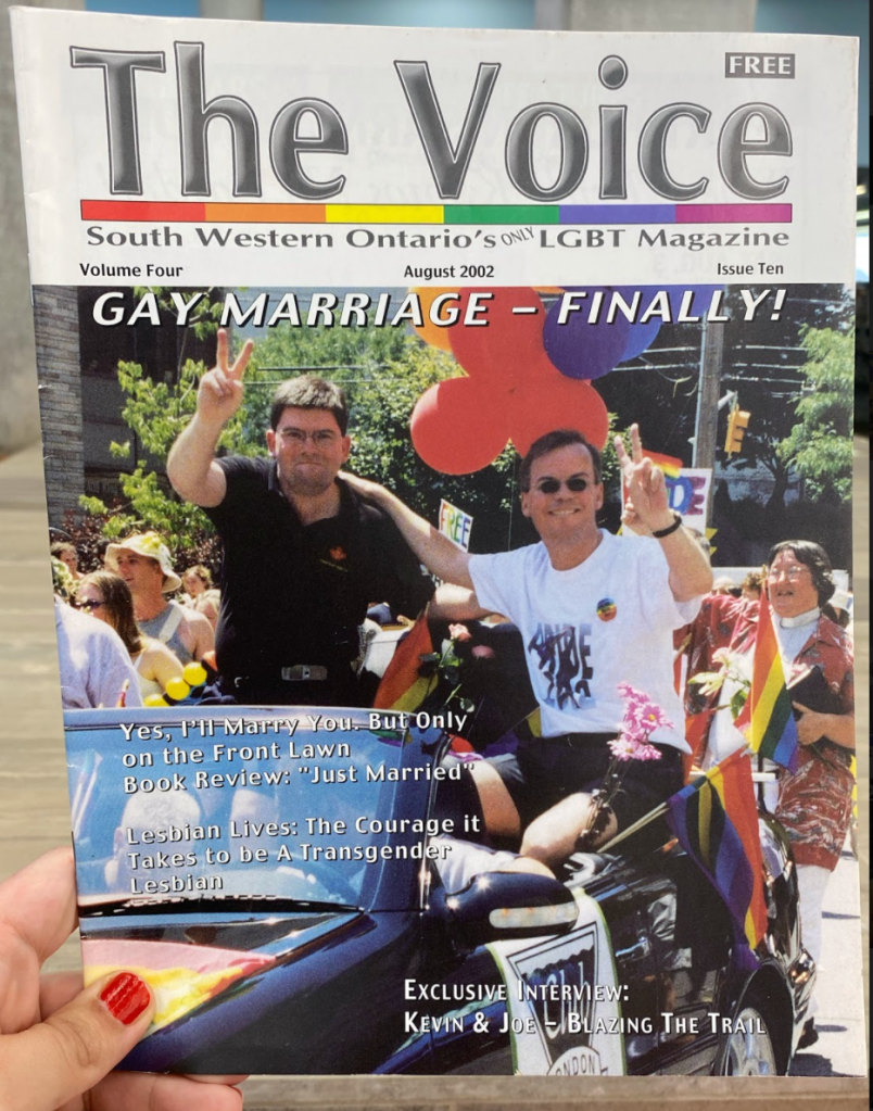 A photograph of The Voice magazine, from August 2002. It is full sized, printed in colour and on glossy paper. This issue celebrates the legalization of same sex marriage in Canada in 2002.